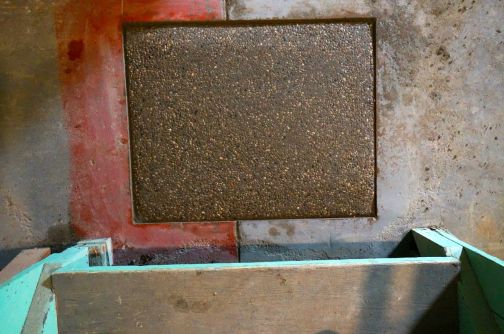 At the base of the stairs where you first step onto the basement floor.