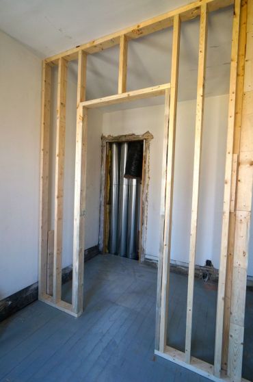 The front second floor bedroom has an arched opening leading into 