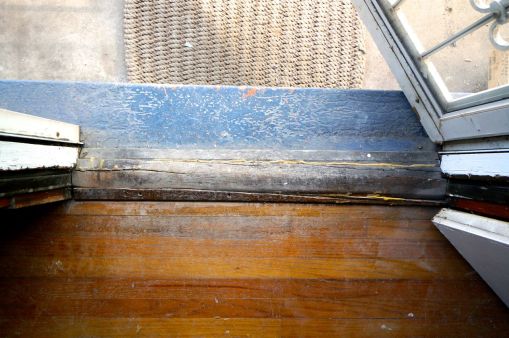 This isn't the original threshold. It was poorly fitted and installed. I was happy to see it go.